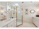 Elegant bathroom featuring a glass shower, gold fixtures, and floral wallpaper at 42 Barre St, Charleston, SC 29401
