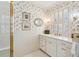 Bathroom with floral wallpaper, window shutters, and white vanity at 42 Barre St, Charleston, SC 29401