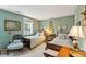 Charming bedroom with twin beds, soft green walls, and vintage decor at 42 Barre St, Charleston, SC 29401