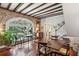 Dining room with exposed brick, hardwood floors, and large window providing natural light and views of outdoors at 42 Barre St, Charleston, SC 29401