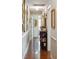 Hallway with hardwood floors, decorative mirrors, and a view into another room at 42 Barre St, Charleston, SC 29401