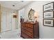 Hallway featuring a dark wood dresser with gold hardware, a large mirror, and framed artwork at 42 Barre St, Charleston, SC 29401