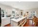 Bright, open kitchen featuring an island with storage, white cabinetry, and a view to the patio at 42 Barre St, Charleston, SC 29401