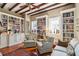 Cozy living room featuring a ceiling fan, hardwood floors, built-in bookshelves, and comfortable seating at 42 Barre St, Charleston, SC 29401