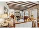 Elegant living room with exposed beams, brick fireplace, and comfortable seating for relaxed gatherings at 42 Barre St, Charleston, SC 29401