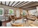 Elegant living room with exposed brick walls, hardwood floors, beamed ceiling, and stylish furnishings at 42 Barre St, Charleston, SC 29401