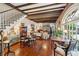 Expansive living area with exposed beams, hardwood floors, large window, and access to stairs at 42 Barre St, Charleston, SC 29401