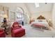 Relaxing main bedroom with a vaulted ceiling, private balcony, and comfortable seating at 42 Barre St, Charleston, SC 29401