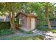 Charming backyard shed with a window box surrounded by lush greenery at 42 Barre St, Charleston, SC 29401