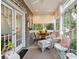 Charming sunroom with brick walls, lots of windows, and comfortable seating area at 42 Barre St, Charleston, SC 29401