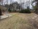 Expansive backyard featuring mature trees and a covered patio, perfect for outdoor entertaining at 4451 Donwood Dr, Ladson, SC 29456