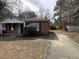 Exterior view featuring a single-story brick home with a driveway and partially visible fenced backyard at 4451 Donwood Dr, Ladson, SC 29456