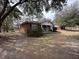 Exterior view of a cozy brick home on a spacious lot with mature trees and a well-maintained lawn at 4451 Donwood Dr, Ladson, SC 29456