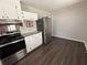 Galley kitchen featuring stainless steel appliances and white cabinets at 4451 Donwood Dr, Ladson, SC 29456