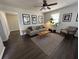 Cozy living room with dark wood floors, contemporary furnishings, stylish art, and indoor plants at 4451 Donwood Dr, Ladson, SC 29456