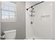 Stylish bathroom with white tiled shower, toilet, and natural light from a window at 4788 Porter Dr, North Charleston, SC 29420
