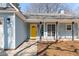 Close-up of a bright yellow front door with a black lantern and brick walkway at 4788 Porter Dr, North Charleston, SC 29420