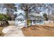 Quaint home with blue siding, garage, and leafless tree in yard at 4788 Porter Dr, North Charleston, SC 29420