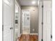 Hallway with hardwood floors leading to a bathroom with white tile and modern fixtures at 4788 Porter Dr, North Charleston, SC 29420