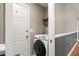 Laundry room with white washer and dryer, located off the hall at 4788 Porter Dr, North Charleston, SC 29420
