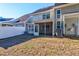 Home's backyard featuring a screened porch and air conditioning units at 546 Tayrn Dr, Charleston, SC 29492
