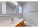 Bathroom with white marble-look vanity top, wood cabinets and framed mirror at 546 Tayrn Dr, Charleston, SC 29492