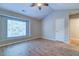Bright bedroom with a large window, ceiling fan, and wood-look flooring at 546 Tayrn Dr, Charleston, SC 29492