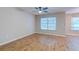 A bedroom with wood floors, a ceiling fan, and two windows makes this a comfortable space at 546 Tayrn Dr, Charleston, SC 29492