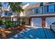 Charming townhome features an attached garage, mature landscaping, and a well-maintained exterior at 546 Tayrn Dr, Charleston, SC 29492