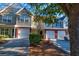 View of townhomes with attached garages and small front lawns at 546 Tayrn Dr, Charleston, SC 29492