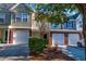 Exterior shot of townhomes with brick and neutral color siding and attached garages at 546 Tayrn Dr, Charleston, SC 29492