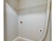 A bright laundry area with overhead shelving, hookups, and light-colored walls at 546 Tayrn Dr, Charleston, SC 29492