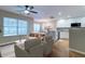 Open-concept living room and kitchen with ample natural light, comfortable seating and modern finishes at 546 Tayrn Dr, Charleston, SC 29492