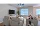 A cozy living room features comfortable seating, a large window, and a modern entertainment setup at 546 Tayrn Dr, Charleston, SC 29492