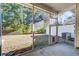 Screened porch with view of fenced backyard, and small dog door on the screen door at 546 Tayrn Dr, Charleston, SC 29492