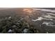 Aerial view of a residential area with mature landscaping, marshland, and waterways at 57 Goldenrod Ct, Kiawah Island, SC 29455