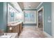 Luxurious bathroom boasts marble tile, double vanity, and glass-enclosed shower at 57 Goldenrod Ct, Kiawah Island, SC 29455