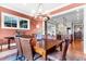 Cozy dining room featuring a rustic table, chandelier lighting, and a view into the kitchen at 57 Goldenrod Ct, Kiawah Island, SC 29455