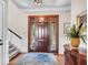 Inviting foyer featuring a beautiful wood door, hardwood floors, and stylish decor creating a warm welcome at 57 Goldenrod Ct, Kiawah Island, SC 29455