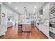 Open concept kitchen with hardwood floors, stainless steel appliances, and modern lighting at 57 Goldenrod Ct, Kiawah Island, SC 29455