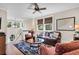 Cozy living room with hardwood floors, area rug, leather sofa, and abundant natural light at 57 Goldenrod Ct, Kiawah Island, SC 29455