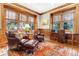 Wood paneled office with multiple windows and comfortable leather seating at 57 Goldenrod Ct, Kiawah Island, SC 29455