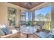 A covered porch with comfortable seating and a view of mature landscaping at 57 Goldenrod Ct, Kiawah Island, SC 29455