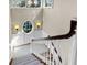 Bright stairwell with elegant windows and white wood banister and carpeted stairs at 57 Goldenrod Ct, Kiawah Island, SC 29455