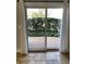 View from inside looking out to a backyard patio surrounded by manicured green shrubbery at 604 Ventura Pl, Mount Pleasant, SC 29464