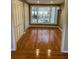 Bedroom with hardwood floors, a large picture window, and shuttered closet doors at 604 Ventura Pl, Mount Pleasant, SC 29464