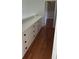 Hallway featuring hardwood floors and built in storage with black hardware at 604 Ventura Pl, Mount Pleasant, SC 29464