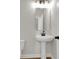 Elegant half-bathroom with a pedestal sink and contemporary black hardware, offering a stylish and space-saving design at 5206 Cottage Lndg Dr, Summerville, SC 29485