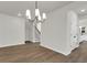 Bright room with a chandelier, hardwood floors, and stairway access creating a welcoming and functional space at 5206 Cottage Lndg Dr, Summerville, SC 29485