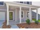 Inviting front porch with gray siding and white columns at 5206 Cottage Lndg Dr, Summerville, SC 29485
